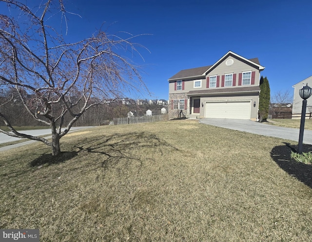 traditional-style house featuring a garage, fence, concrete driveway, and a front yard