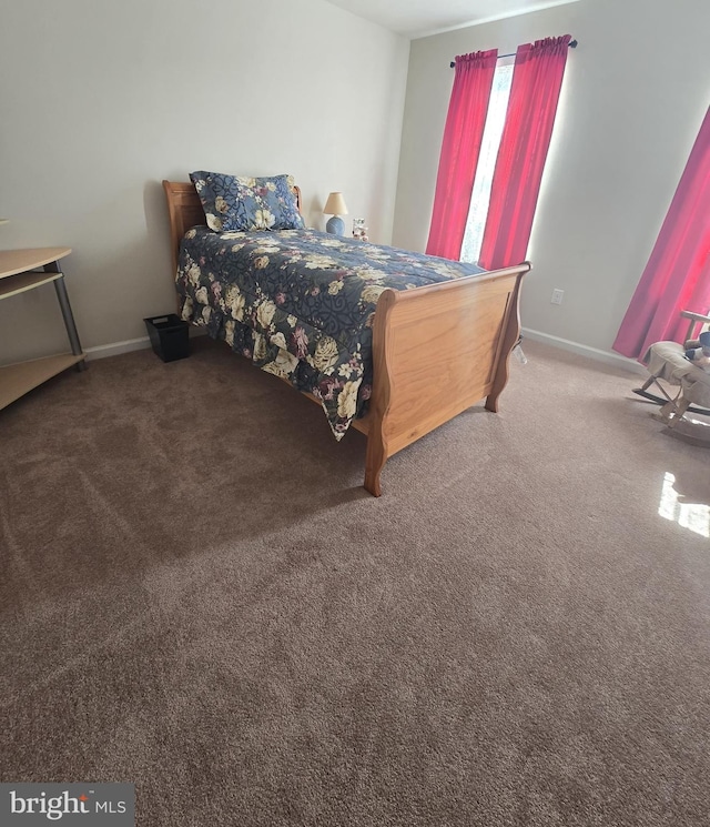 bedroom featuring baseboards and carpet