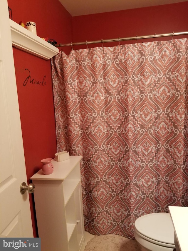 full bath featuring vanity and toilet