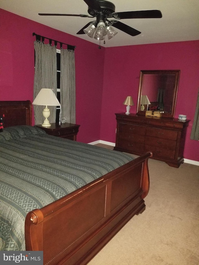 bedroom with a ceiling fan and carpet