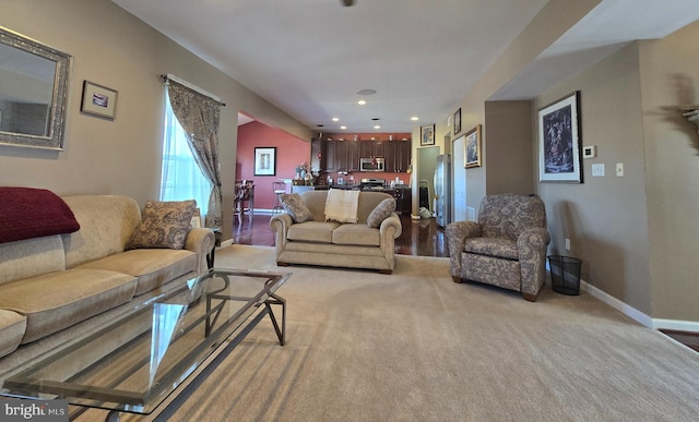 living area with recessed lighting and baseboards