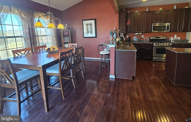 dining room featuring baseboards, dark wood-style floors, and lofted ceiling
