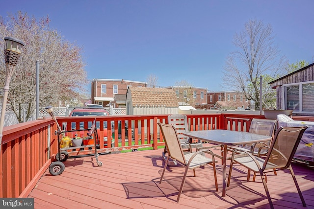 wooden deck featuring outdoor dining area