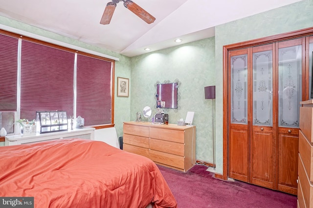 bedroom with dark carpet, vaulted ceiling, and ceiling fan