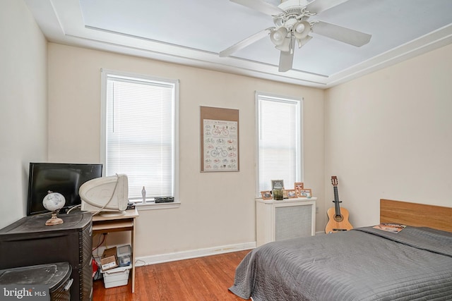 bedroom with baseboards and wood finished floors