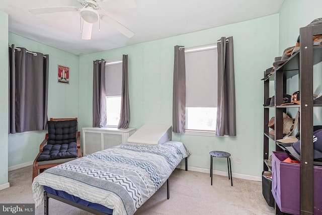 carpeted bedroom with baseboards and a ceiling fan