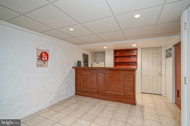 bar featuring recessed lighting, a paneled ceiling, bar area, and light tile patterned floors