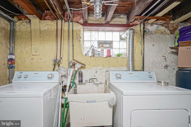 laundry room with a sink, independent washer and dryer, and laundry area
