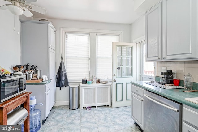 kitchen with backsplash, appliances with stainless steel finishes, and a ceiling fan
