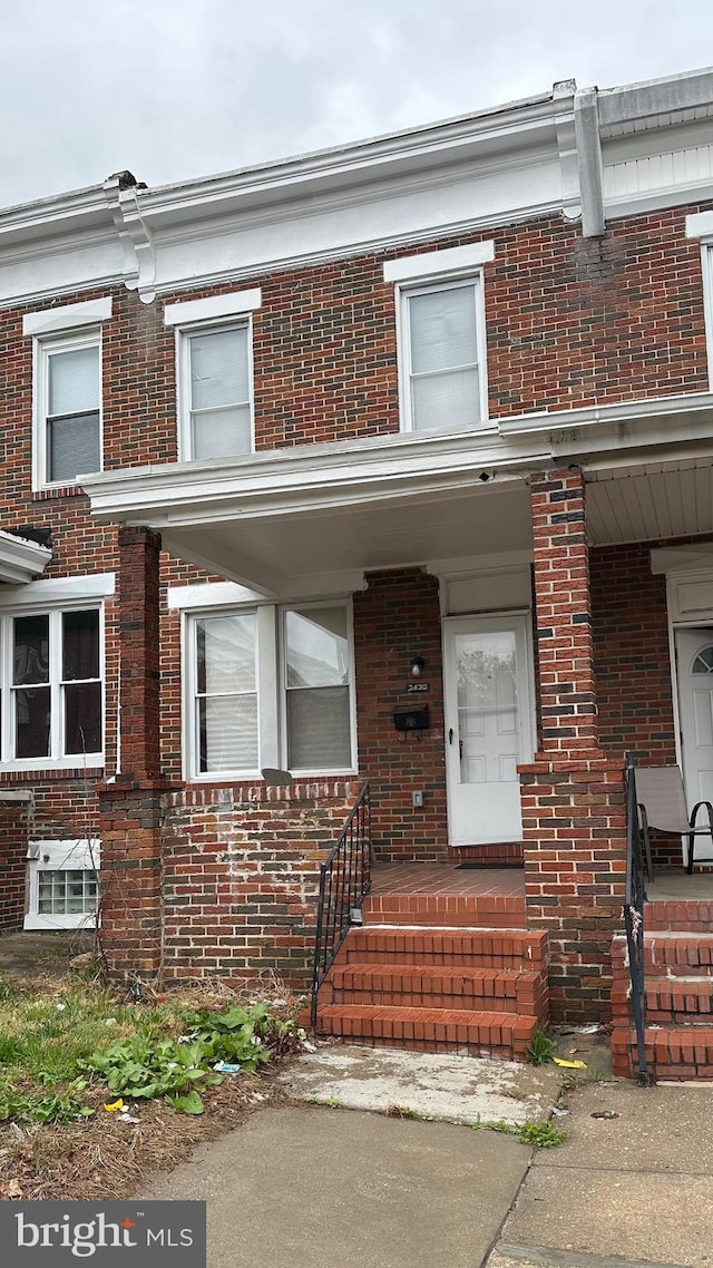 view of front of property with brick siding and a porch