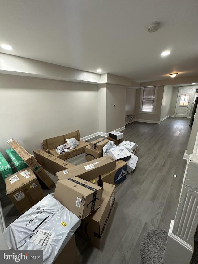 interior space featuring baseboards, recessed lighting, and wood finished floors