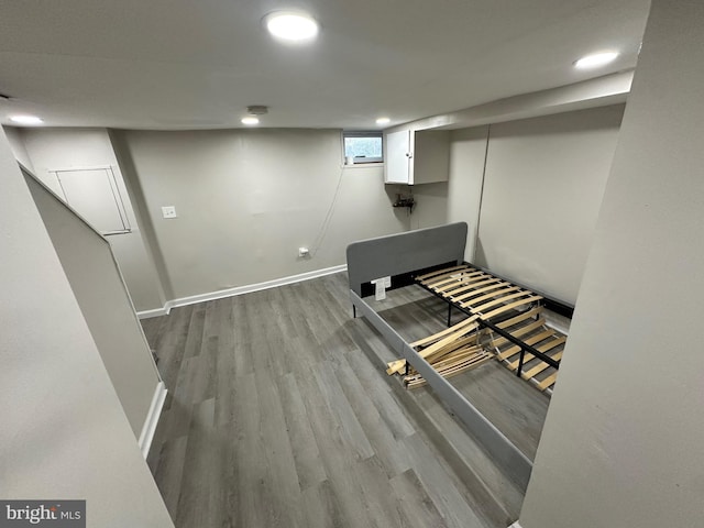 below grade area featuring baseboards, recessed lighting, and wood finished floors