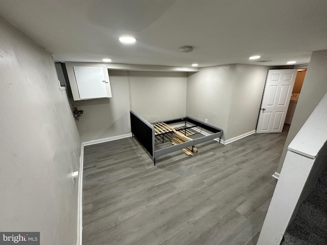 finished basement featuring baseboards, recessed lighting, and wood finished floors