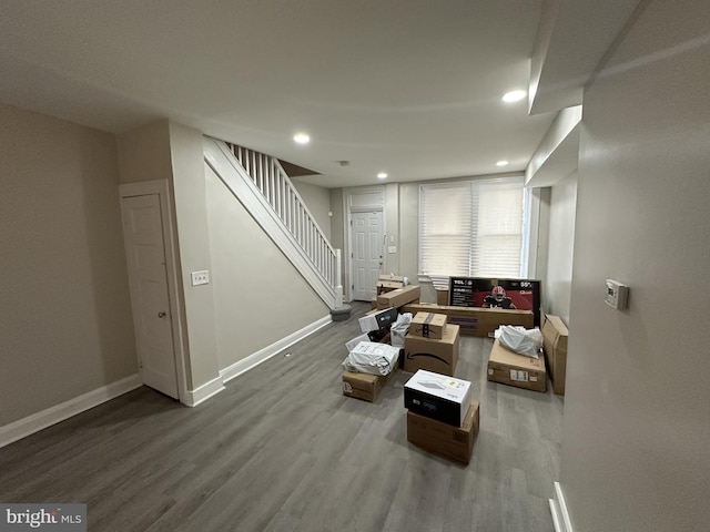 living room with baseboards, recessed lighting, stairs, and wood finished floors