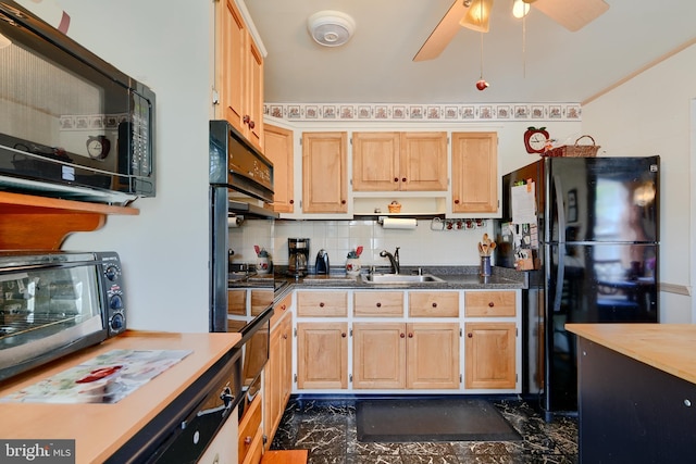 kitchen featuring a sink, light brown cabinetry, black appliances, and tasteful backsplash