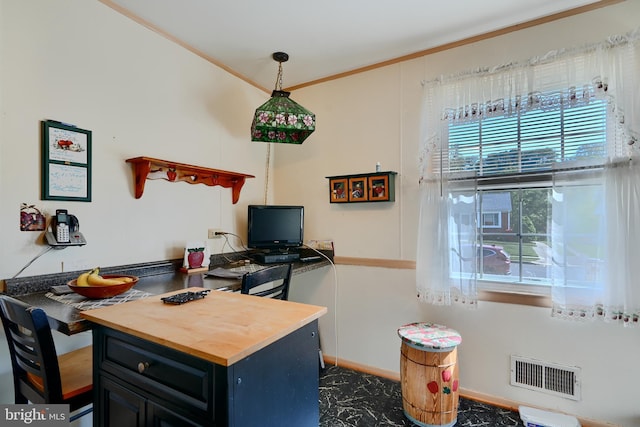 home office featuring crown molding, baseboards, and visible vents