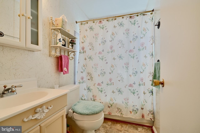 bathroom with toilet, shower / tub combo, and vanity