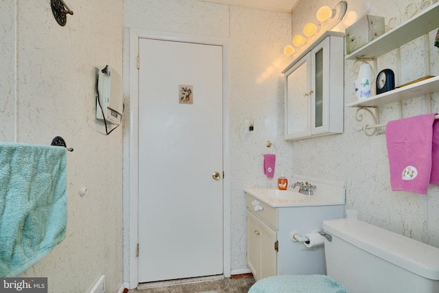 bathroom featuring vanity and toilet