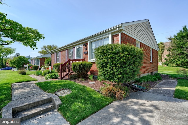 view of front of property with brick siding and a front lawn