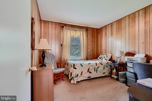 bedroom featuring carpet flooring and wooden walls