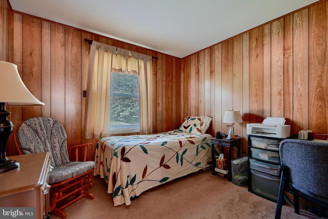 bedroom featuring carpet flooring and wooden walls