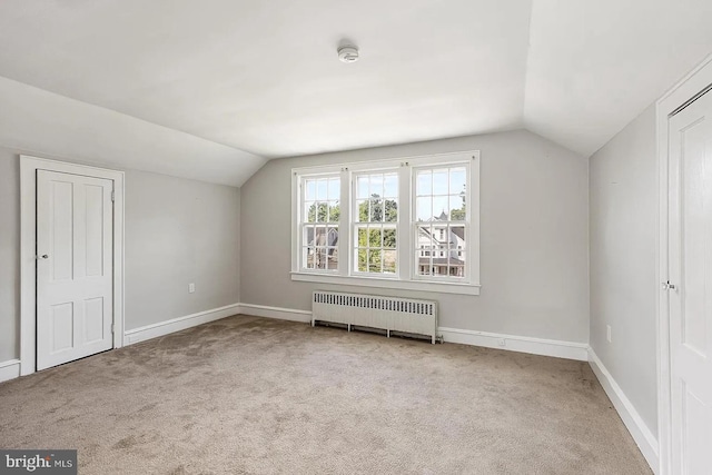 bonus room featuring radiator, baseboards, carpet, and lofted ceiling