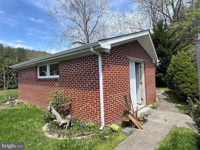 view of home's exterior with brick siding and entry steps