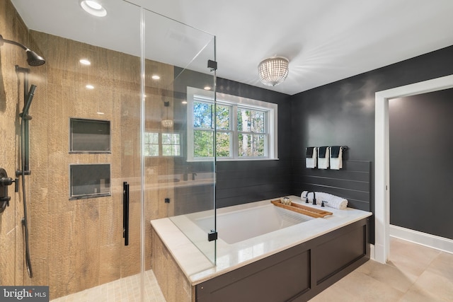 bathroom featuring tile patterned floors, a shower stall, and a bath