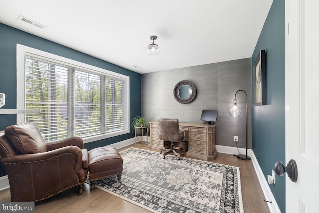 office area featuring baseboards, wood finished floors, and visible vents