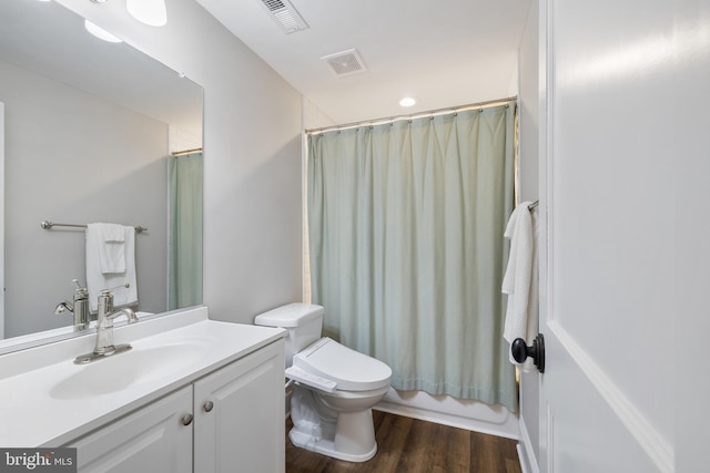 full bath featuring visible vents, wood finished floors, toilet, and vanity