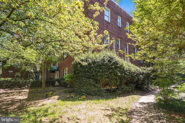 view of property exterior with brick siding