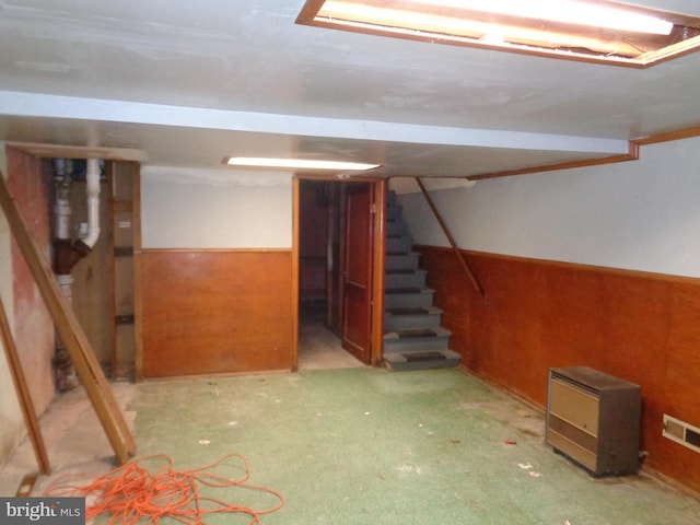 finished below grade area with a wainscoted wall, stairs, and visible vents
