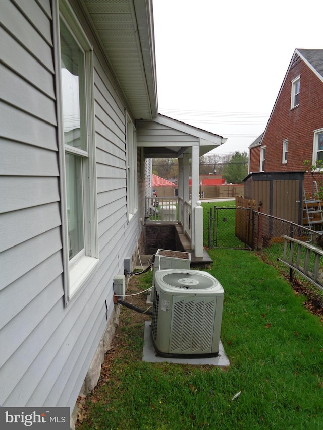 view of yard with fence and central air condition unit