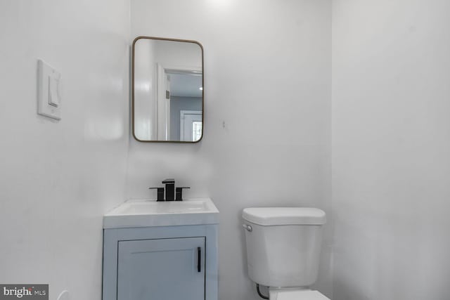 bathroom featuring toilet and vanity