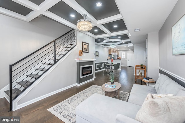 living area with beamed ceiling, visible vents, stairs, coffered ceiling, and hardwood / wood-style flooring