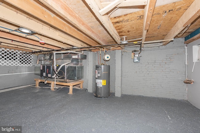 unfinished basement featuring electric water heater and brick wall