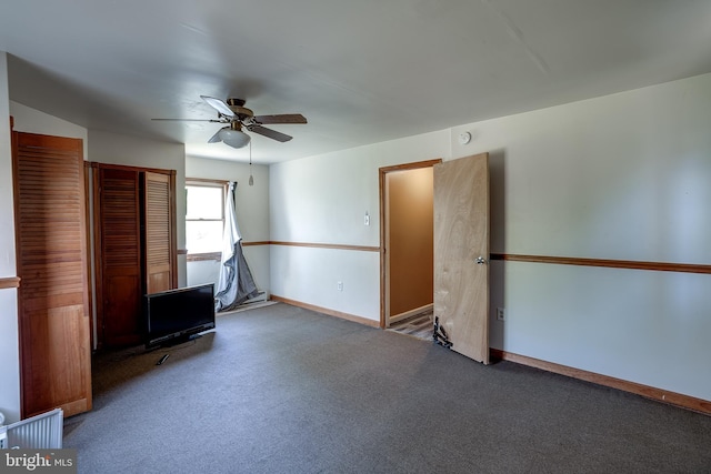 carpeted empty room with baseboards and ceiling fan