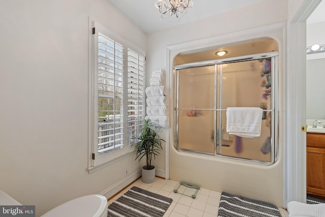 bathroom featuring an inviting chandelier, toilet, vanity, shower / bath combination with glass door, and tile patterned floors