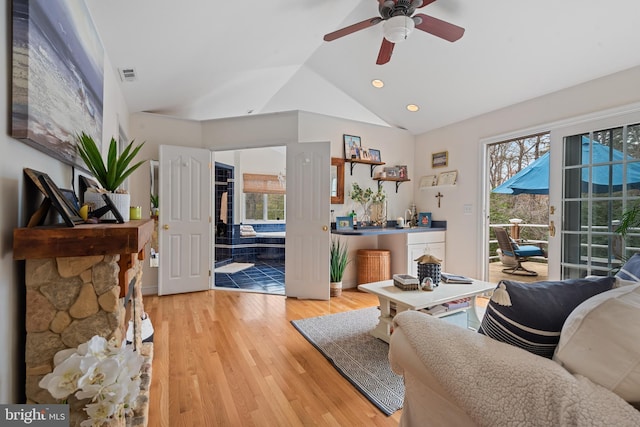 living area with light wood finished floors, visible vents, recessed lighting, lofted ceiling, and ceiling fan