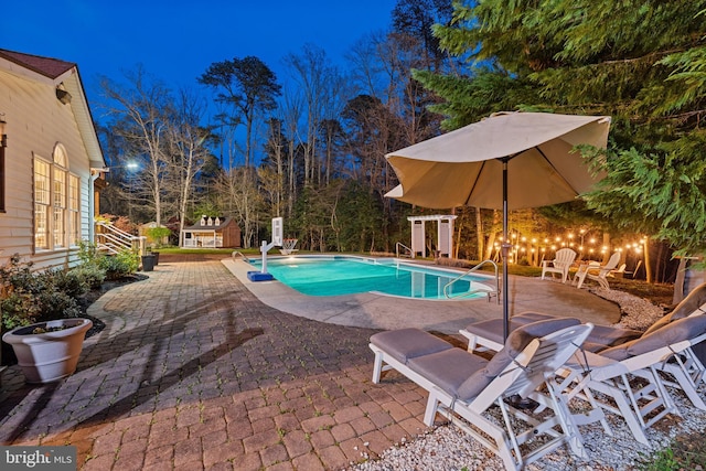 outdoor pool with a patio area