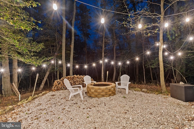 yard at twilight featuring a fire pit