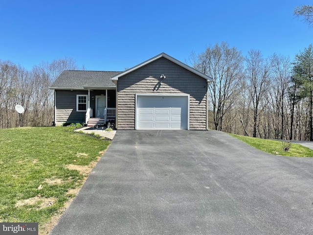 ranch-style house with an attached garage, a front lawn, and aphalt driveway