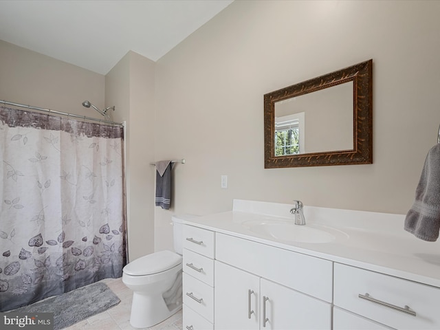 bathroom featuring curtained shower, toilet, vanity, and tile patterned floors