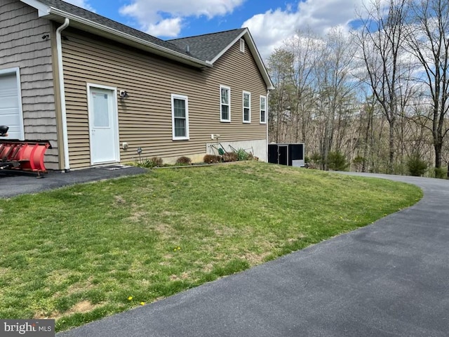 view of property exterior with a lawn