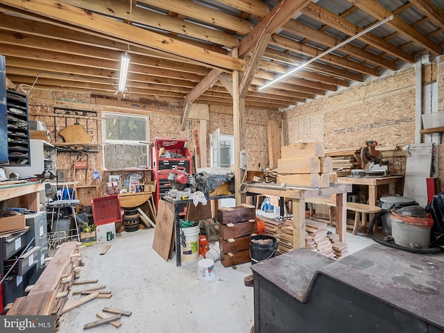 interior space with unfinished concrete floors and a workshop area