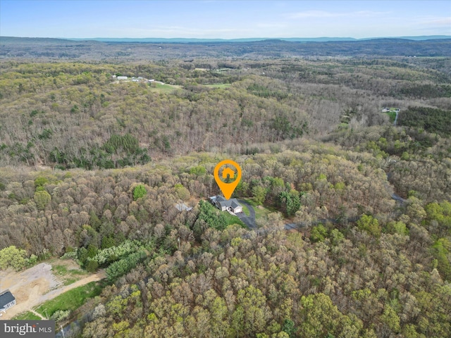 birds eye view of property with a forest view