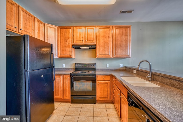 kitchen featuring visible vents, under cabinet range hood, a sink, light tile patterned floors, and black appliances