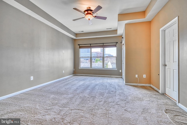 unfurnished room featuring baseboards, ceiling fan, carpet, and visible vents