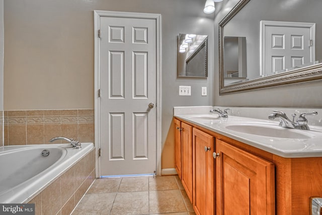 bathroom with a sink, tile patterned flooring, double vanity, and a bath