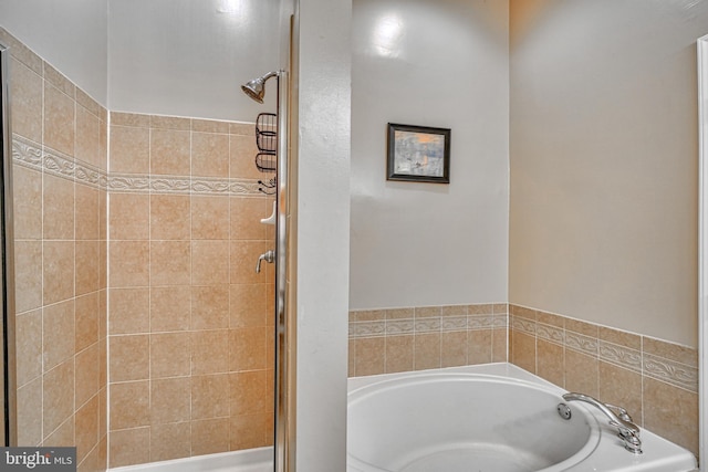 bathroom with a garden tub and a stall shower